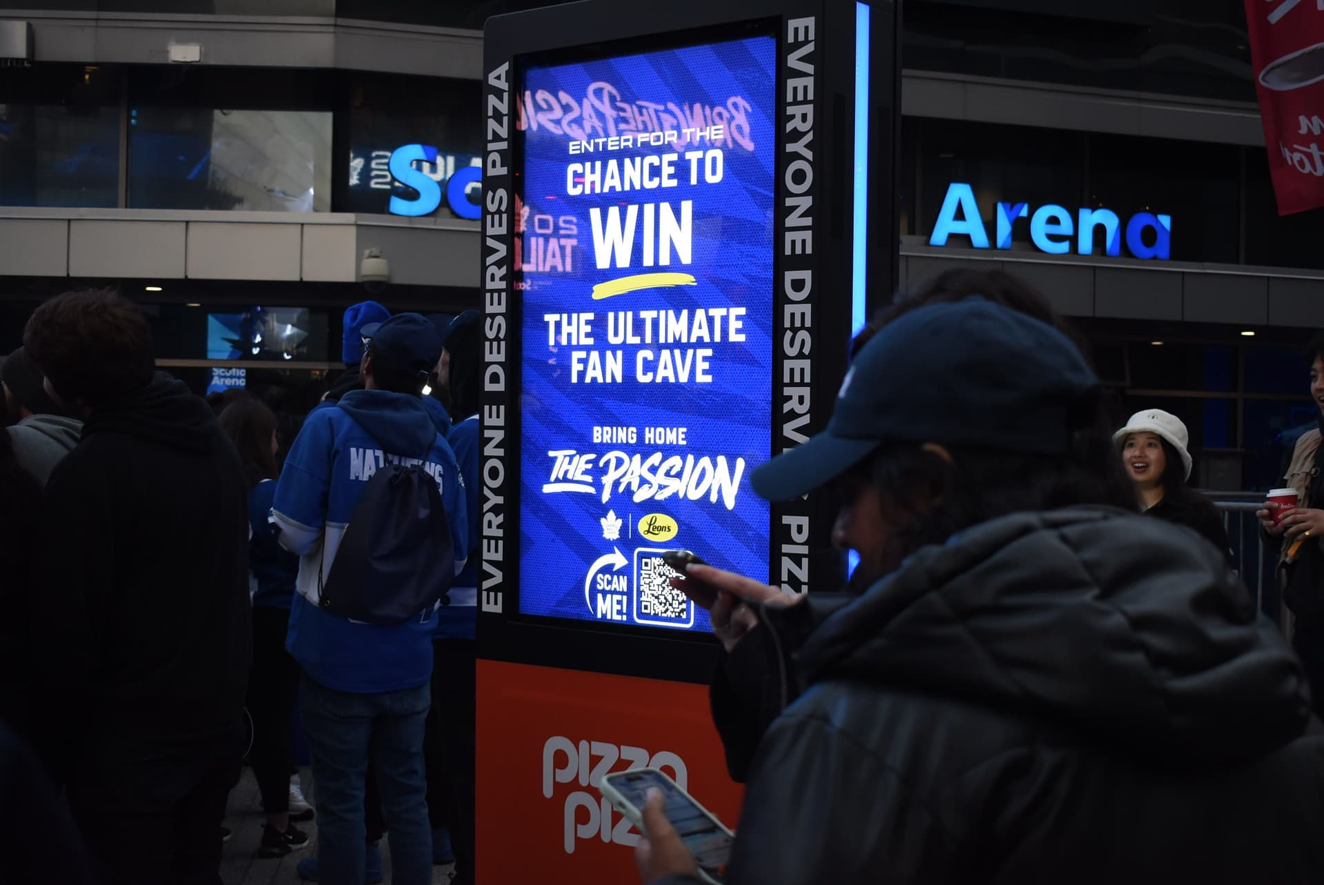 Fans interacting with a BIG Digital touchscreen kiosk during an NHL Playoffs activation, showcasing interactive fan engagement technology at a live sports venue.